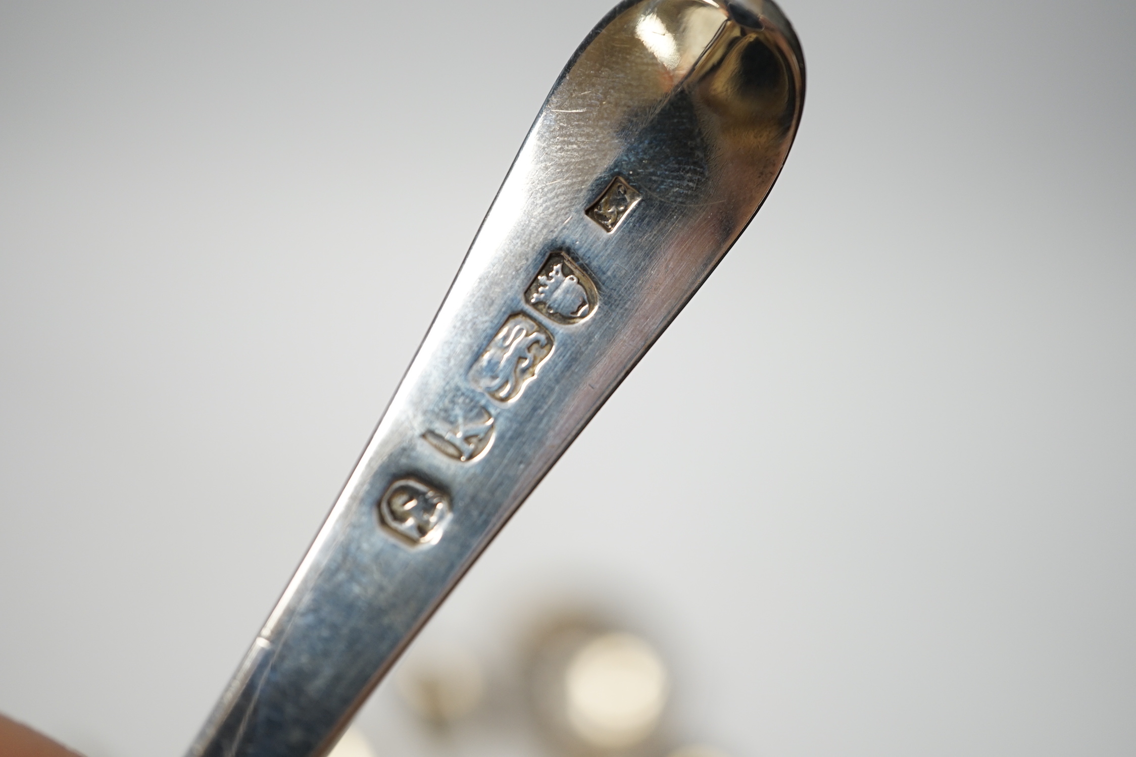 An 18th century silver mote spoon, marks rubbed, 11.8cm and five other various silver spoons and a pair of silver sugar tongs, 5.1oz.